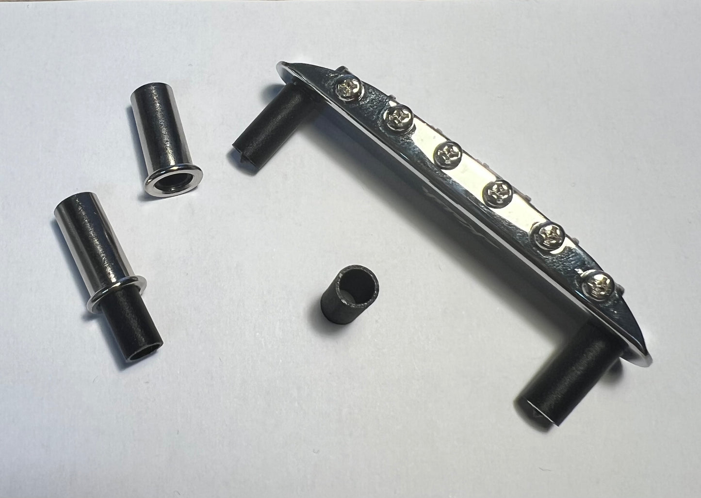 Offset bridge stud sleeves (makes bridge non-rocking)